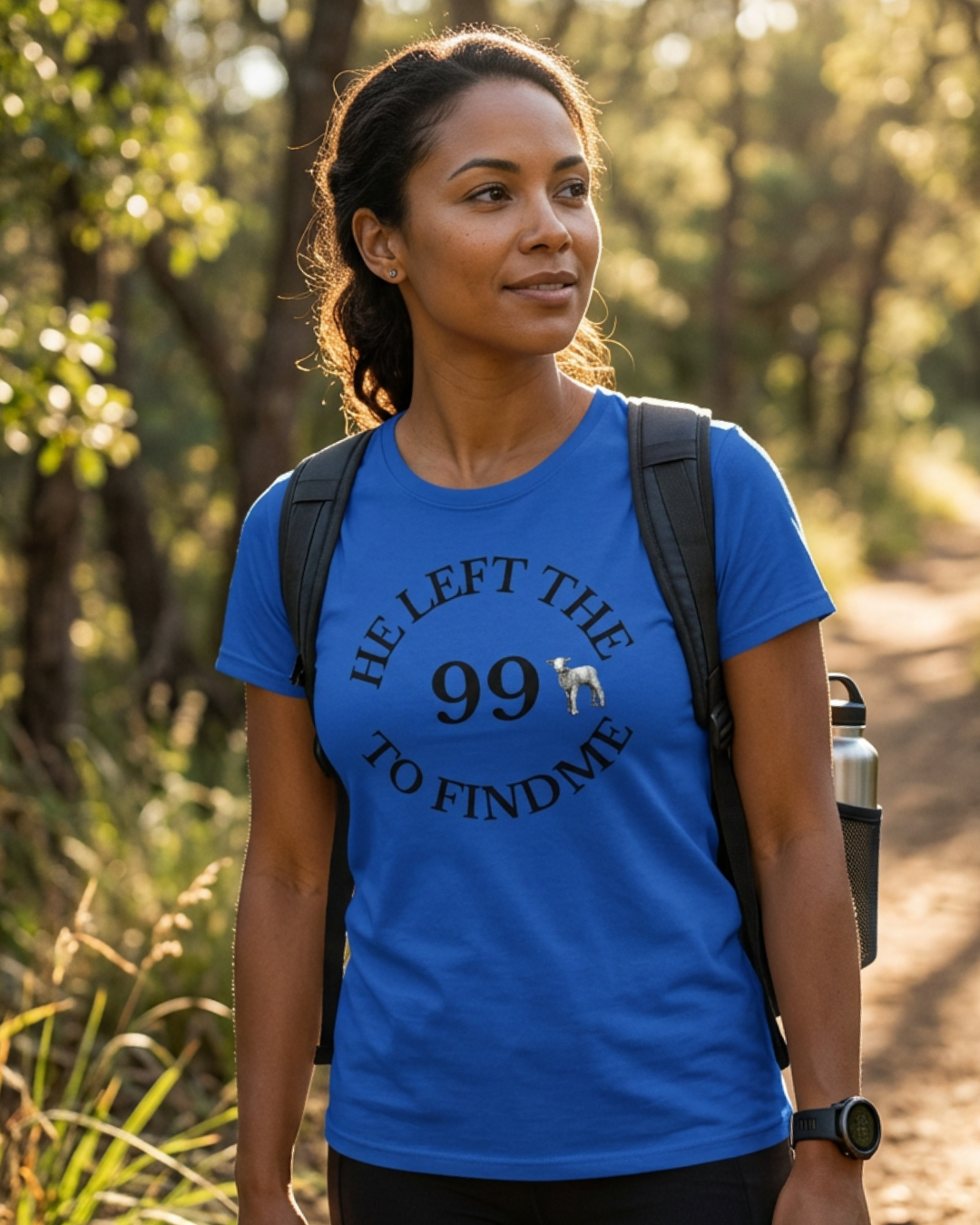 Woman wearing a blue t-shirt with text and a dog graphic, standing outdoors.